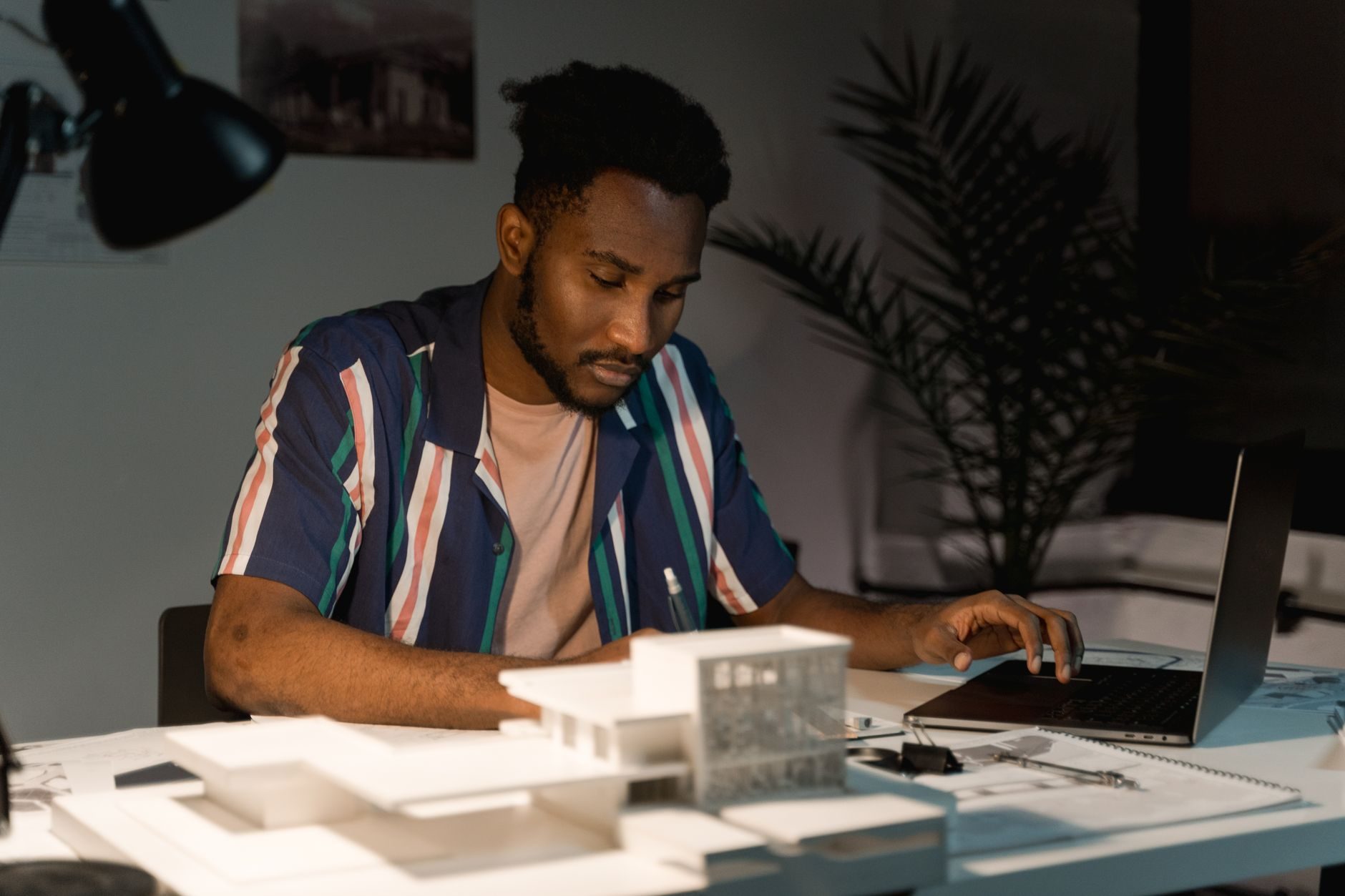 Focused man working at a desk in the evening